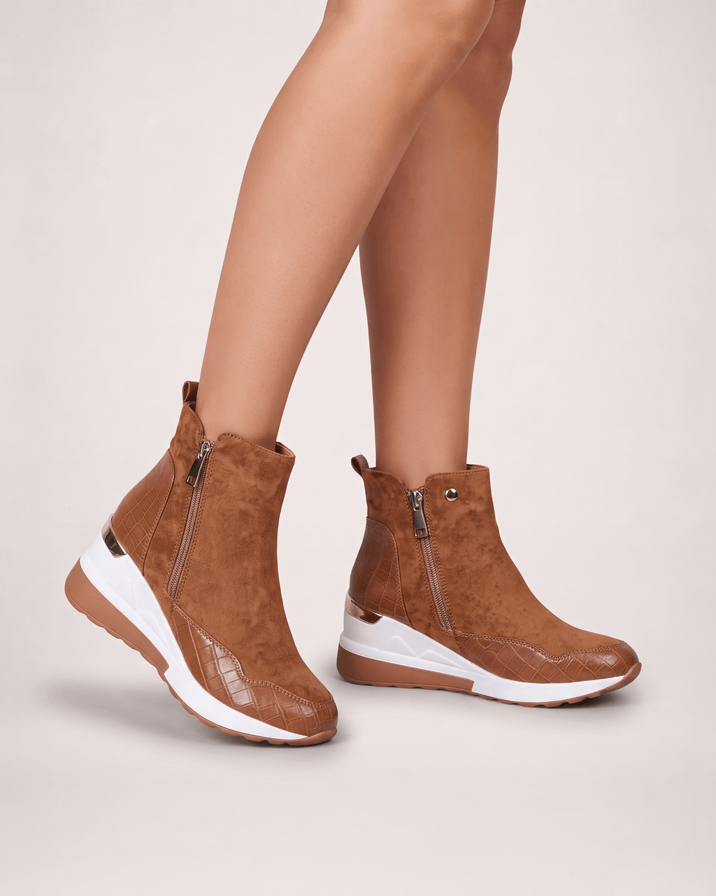 Light brown women’s wedge ankle boots worn in a front three-quarter pose