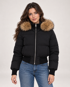 Women's black cropped puffer jacket with faux fur hood trim front view