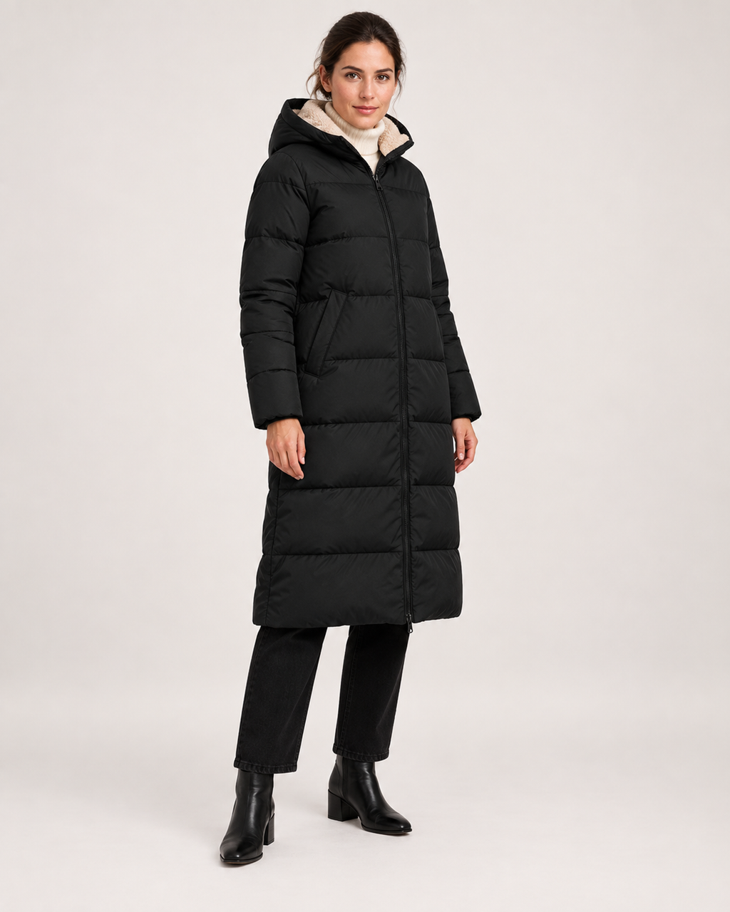 Women’s black long puffer coat fully closed three quarter view