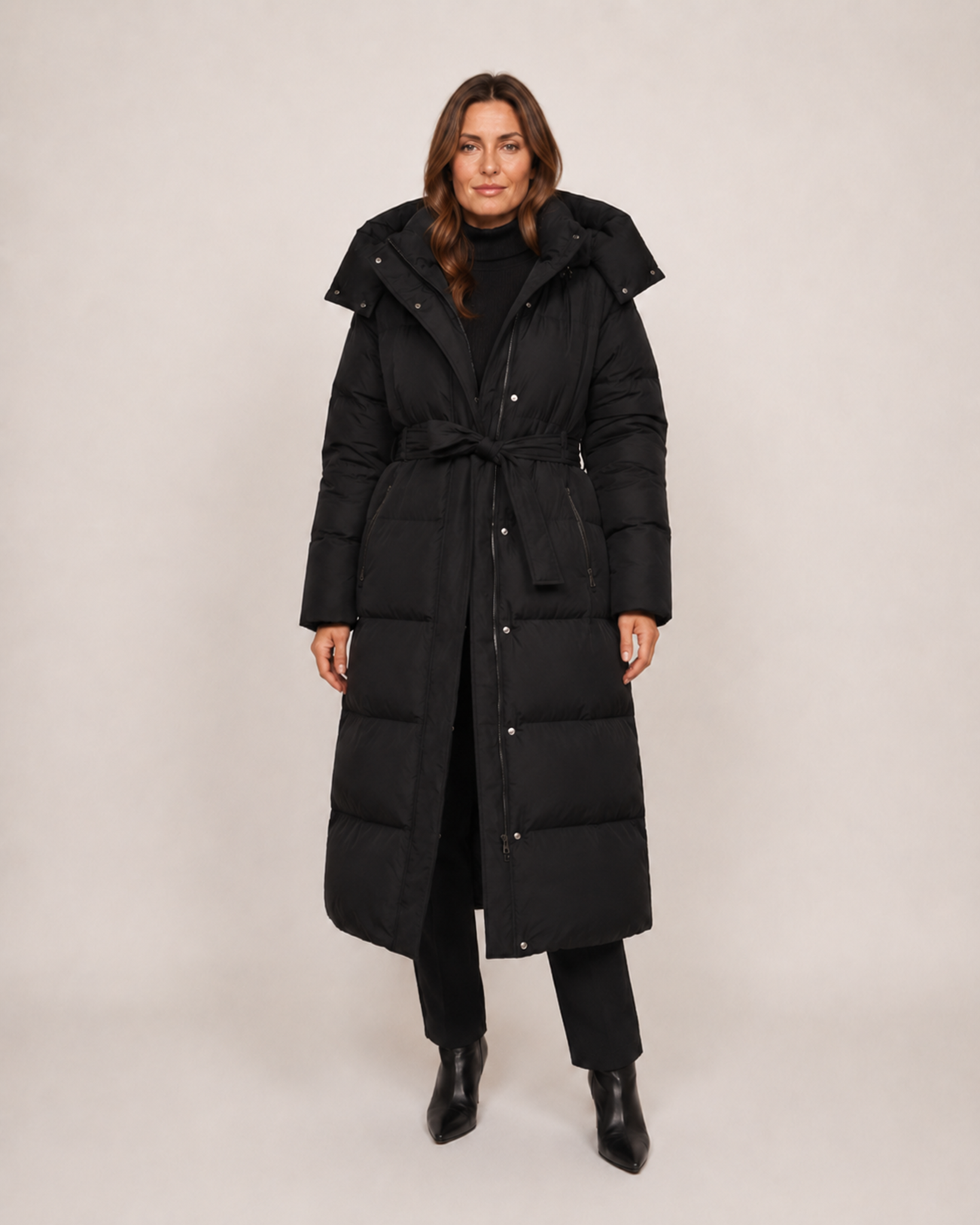 Women’s Long Puffer Coat with Hood and Belt in Black, three quarter body view