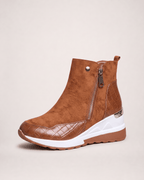 Light brown women’s wedge ankle boot in an outer three-quarter view