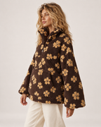 Women’s borg jacket with floral pattern and half zip near profile view