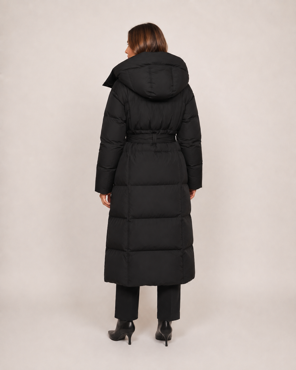 Women’s Long Puffer Coat with Hood and Belt in Black, three quarter body view