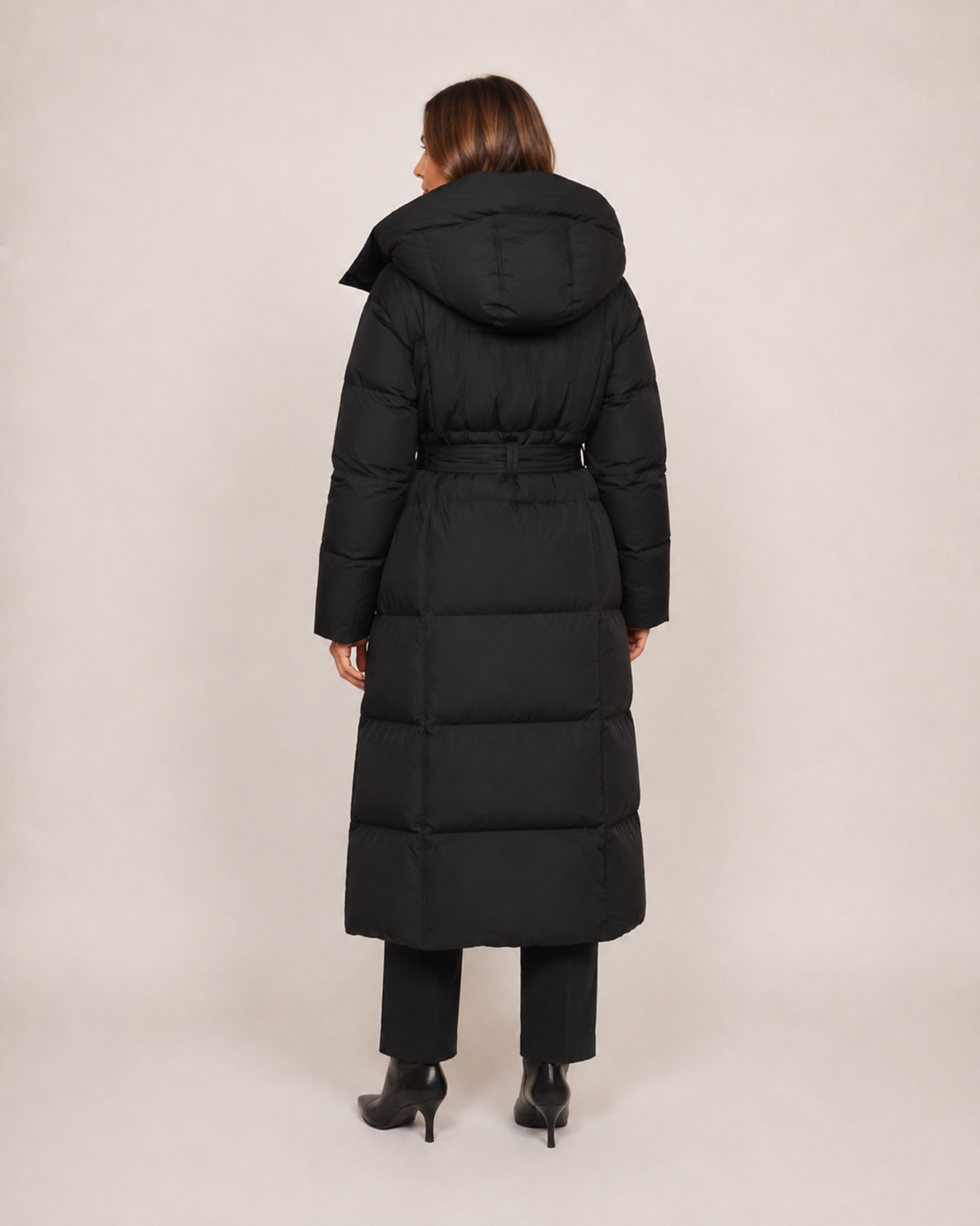 Women’s Long Puffer Coat with Hood and Belt in Black, three quarter body view