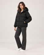 Women’s Puffer Jacket with Hood and Zip Front in Black, three quarter body view