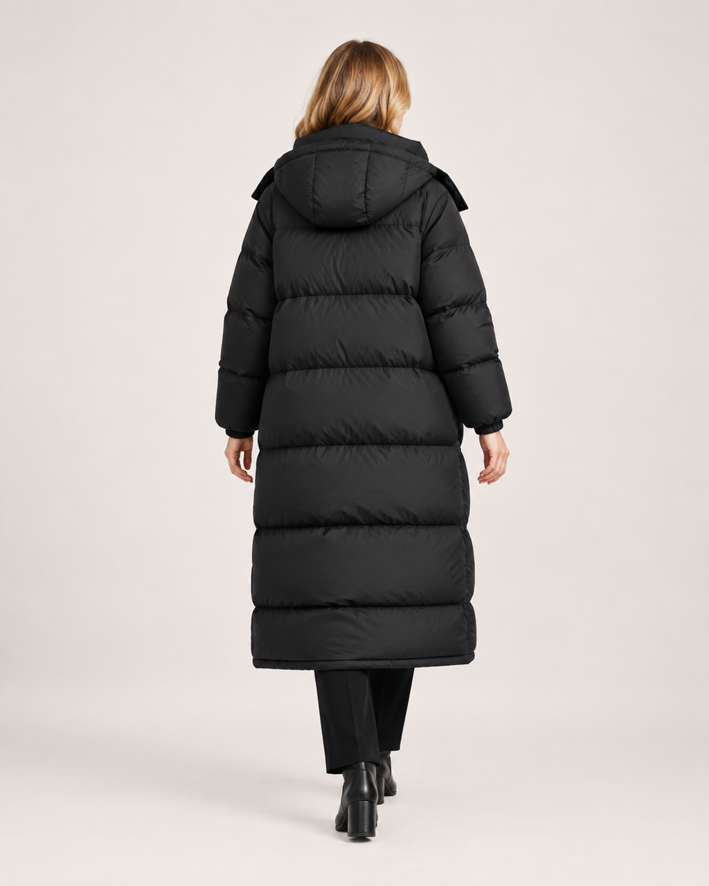 Women’s Long Puffer Coat with Hood and Oversized Fit in Black, three quarter body view