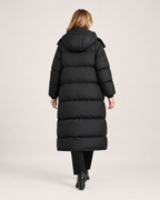 Women’s Long Puffer Coat with Hood and Oversized Fit in Black, three quarter body view