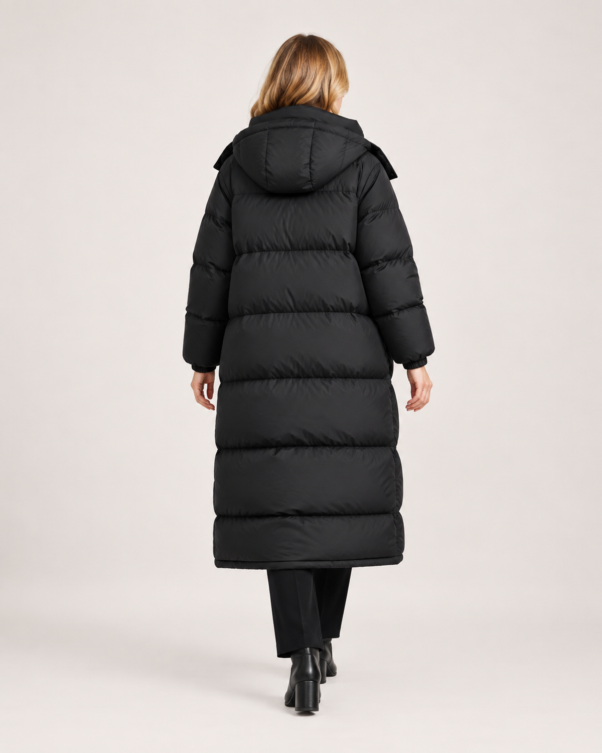 Women’s Long Puffer Coat with Hood and Oversized Fit in Black, three quarter body view