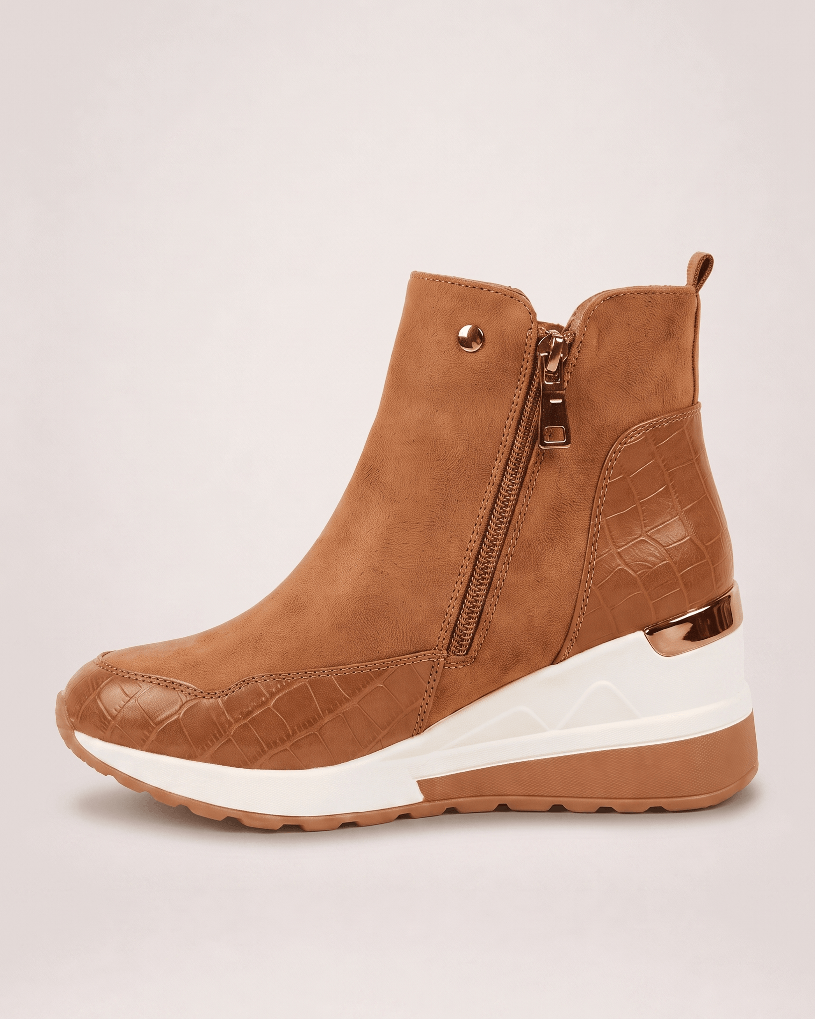 Light brown women’s wedge ankle boot showing the side zip and textured panels