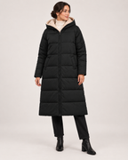 Women’s black long puffer coat fully closed standing view