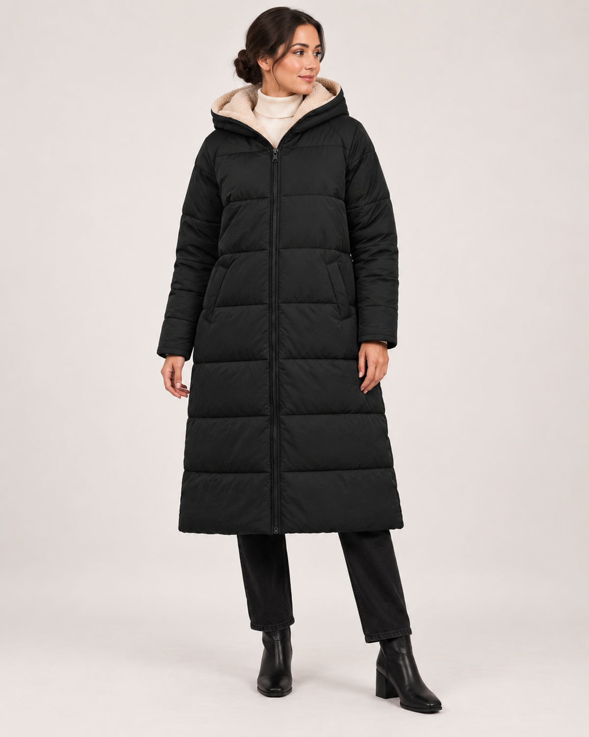 Women’s black long puffer coat fully closed standing view