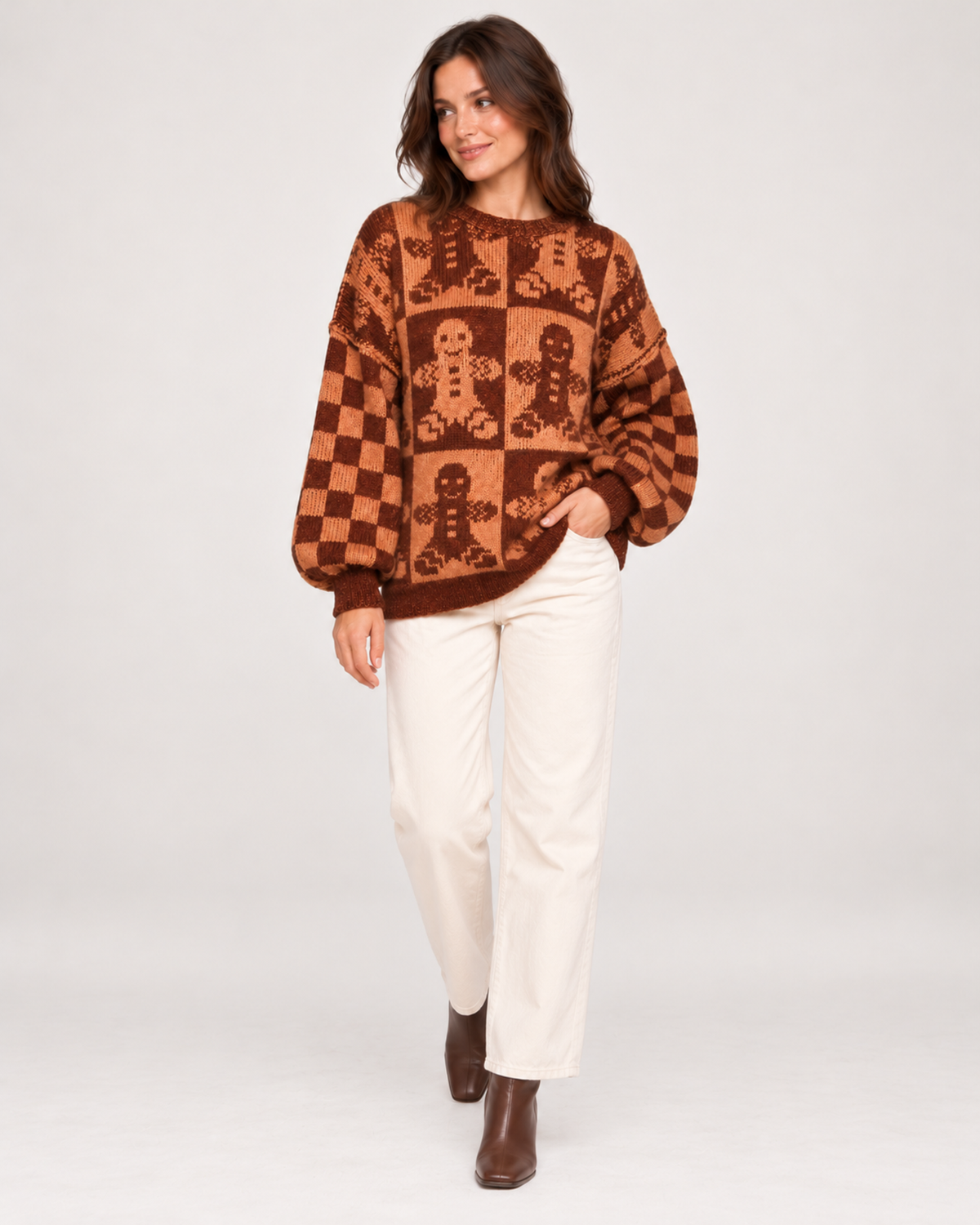 Women's brown gingerbread Christmas jumper styled with cream trousers