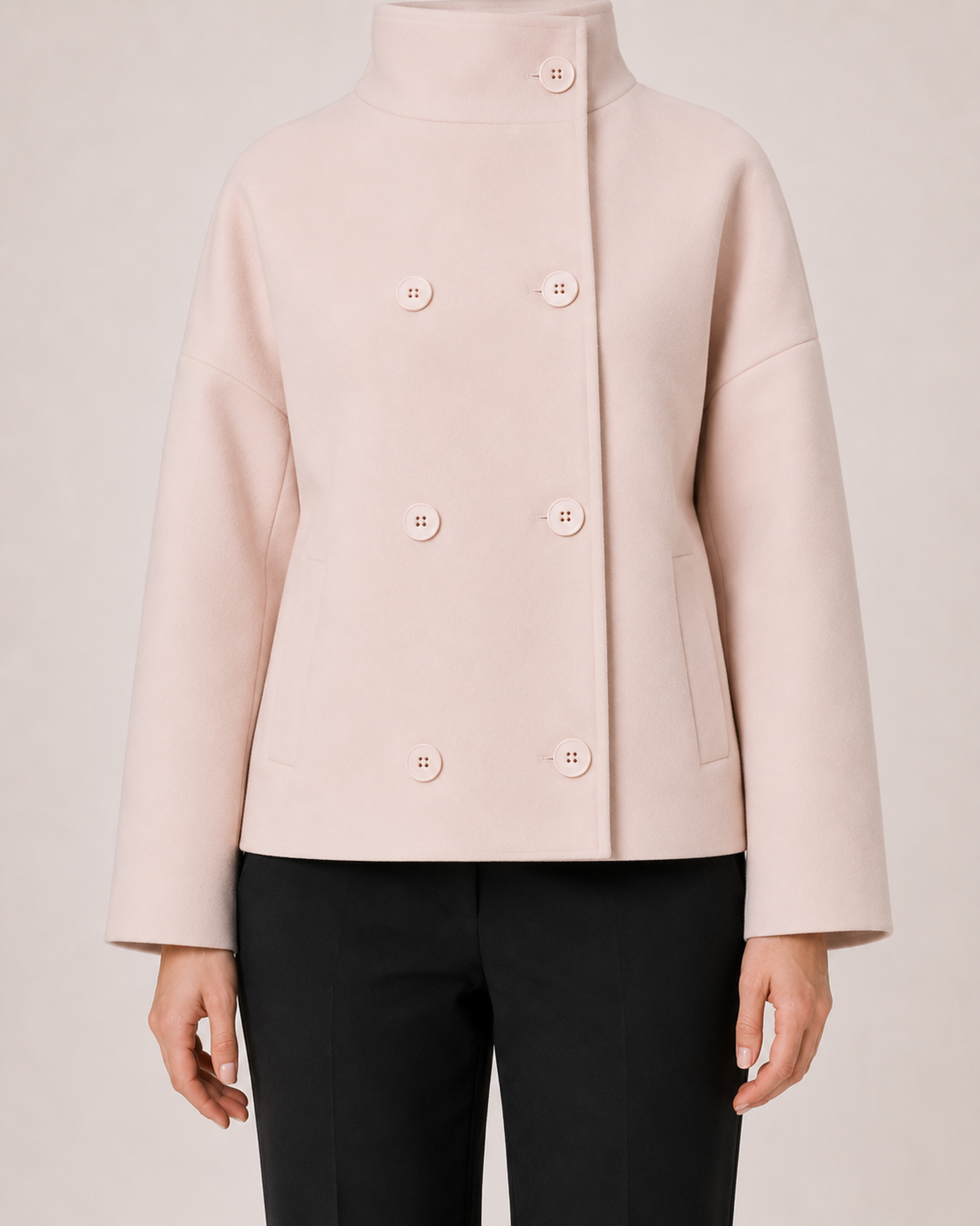 Women’s pink funnel neck coat button and pocket detail