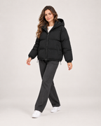 Women’s Puffer Jacket with Hood and Zip Front in Black, three quarter body view