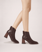 Dark Brown women’s boots worn in a side-on stepping pose