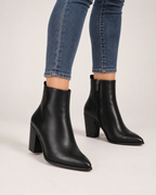 Women’s Heeled Ankle Boots with Side Zip in Black, worn footwear focus below knee view