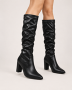 Women’s Knee High Boots with Pointed Toe and High Heel in Black, worn footwear focus below knee view