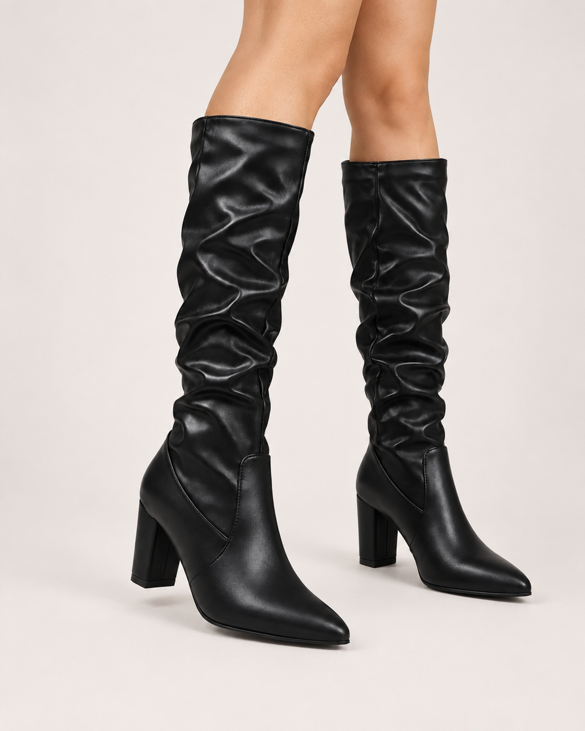Women’s Knee High Boots with Pointed Toe and High Heel in Black, worn footwear focus below knee view