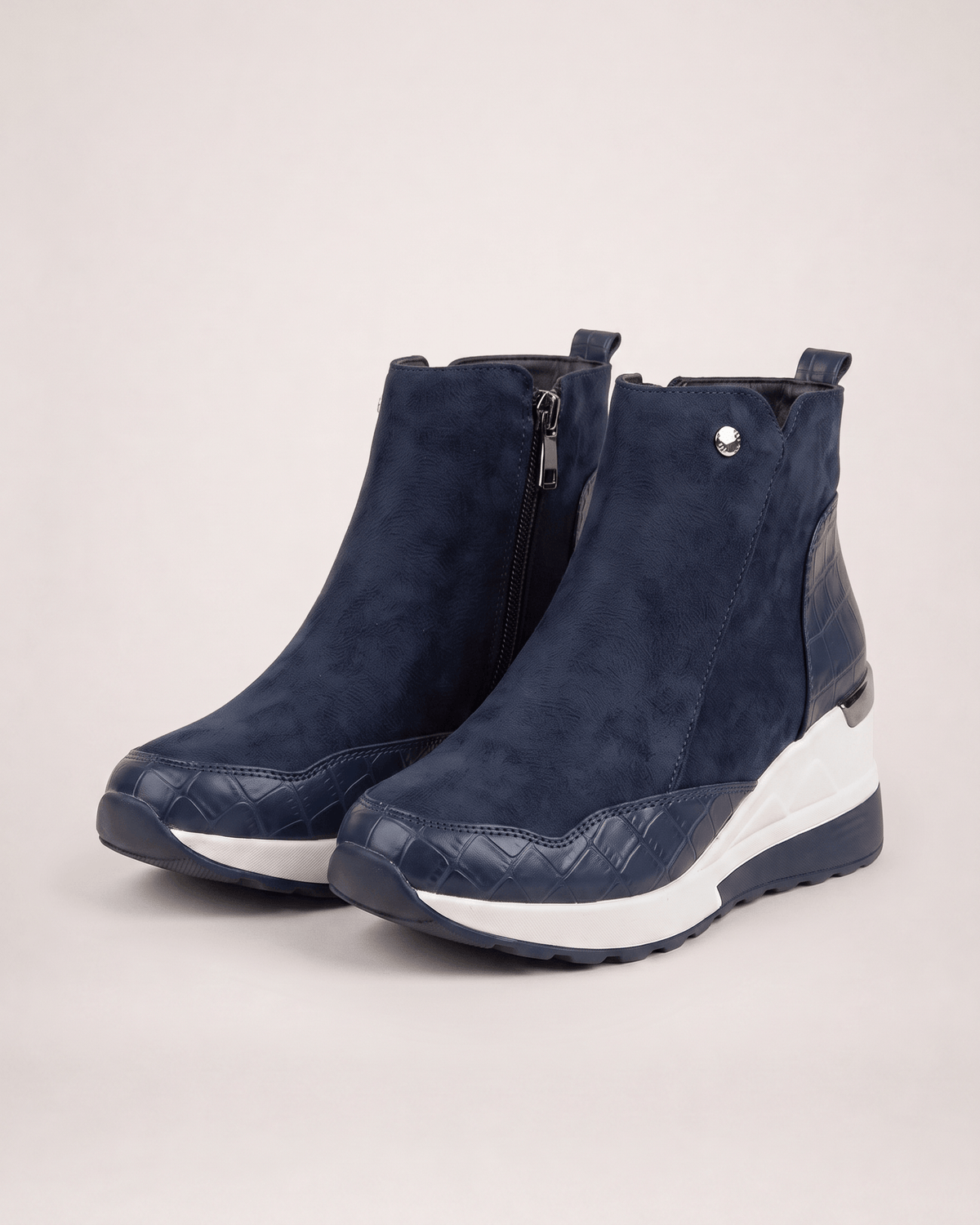 Blue women’s wedge ankle boots in a three-quarter pair view