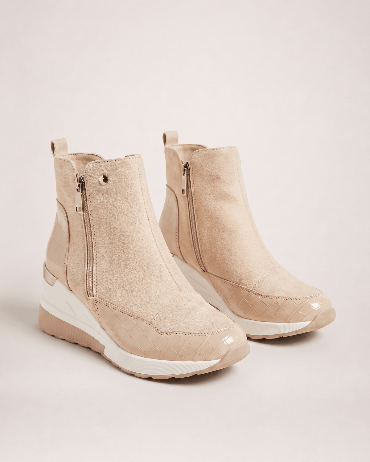 Beige women’s wedge ankle boots in a three-quarter pair view